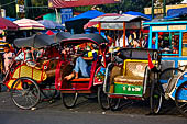 Riding the becak, the local cycle rickshaws in Malioboro street Yogyakarta. 